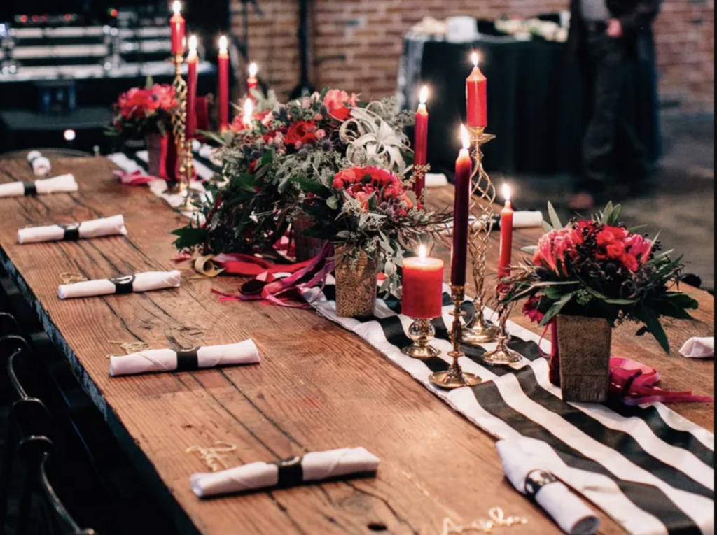 Red, white and black wedding decor with candles for a romantic February Wedding