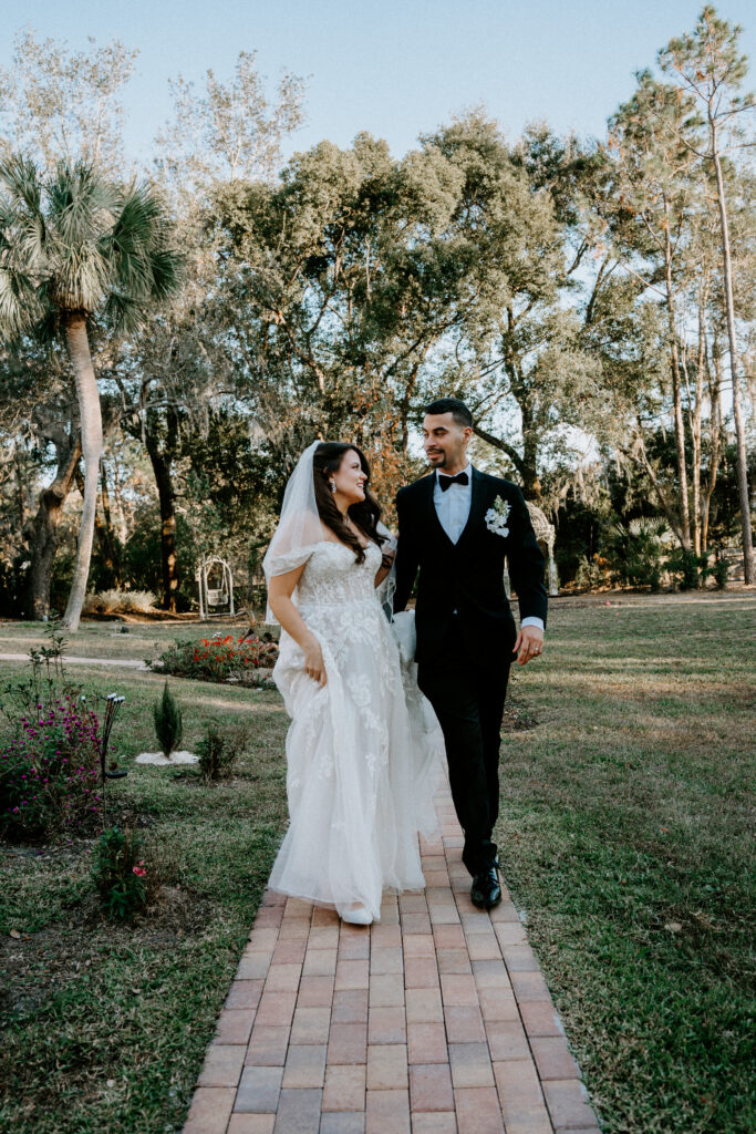 Bride and groom walking on outdoor garden
